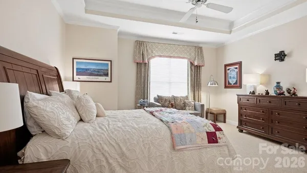 a bedroom with a large bed and a couch