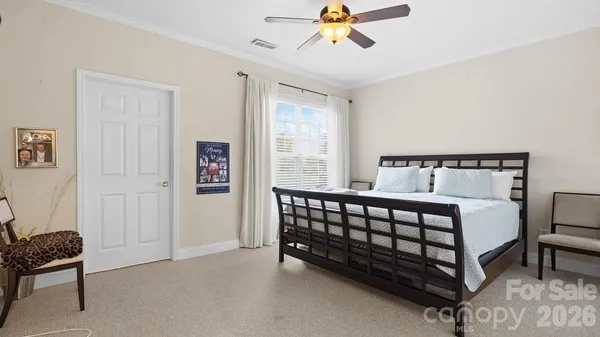 a bedroom with a bed and painting on the wall
