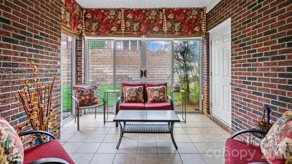 a balcony with furniture and a potted plant
