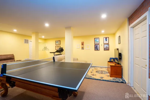 a room with pool table and windows