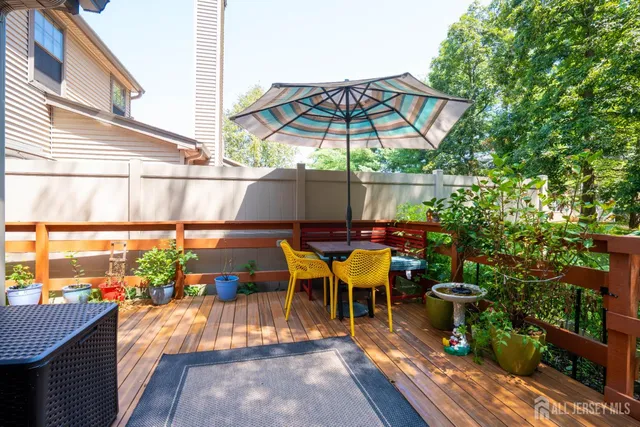 a view of deck with furniture and umbrella