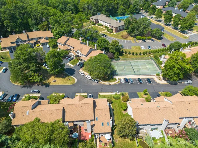 an aerial view of multiple houses with yard