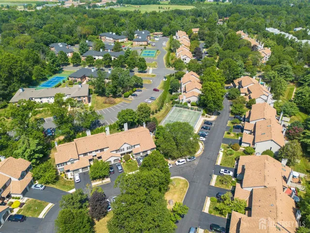 an aerial view of residential houses with outdoor space