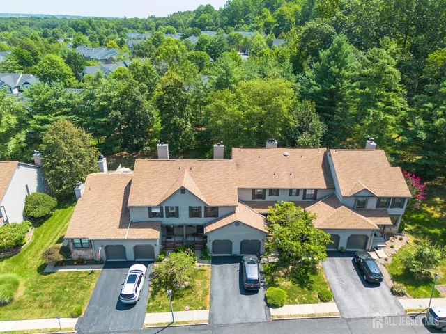 an aerial view of a house with swimming pool and garden