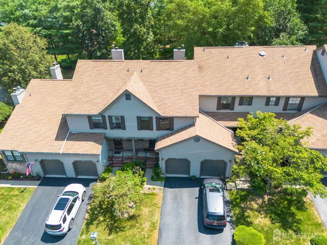 a aerial view of a house with swimming pool next to a yard