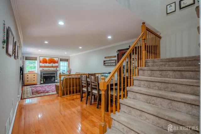 a view of entryway livingroom and hall with wooden floor