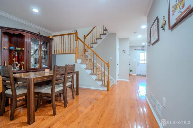 a dining room with furniture and wooden floor