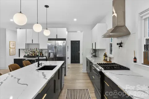 a kitchen with counter space appliances and furniture