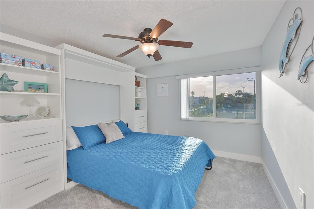 14800 Walsingham Road, Unit 1203 Largo, FL 33774 - Photo 20 of 68 a bedroom with a bed and a window