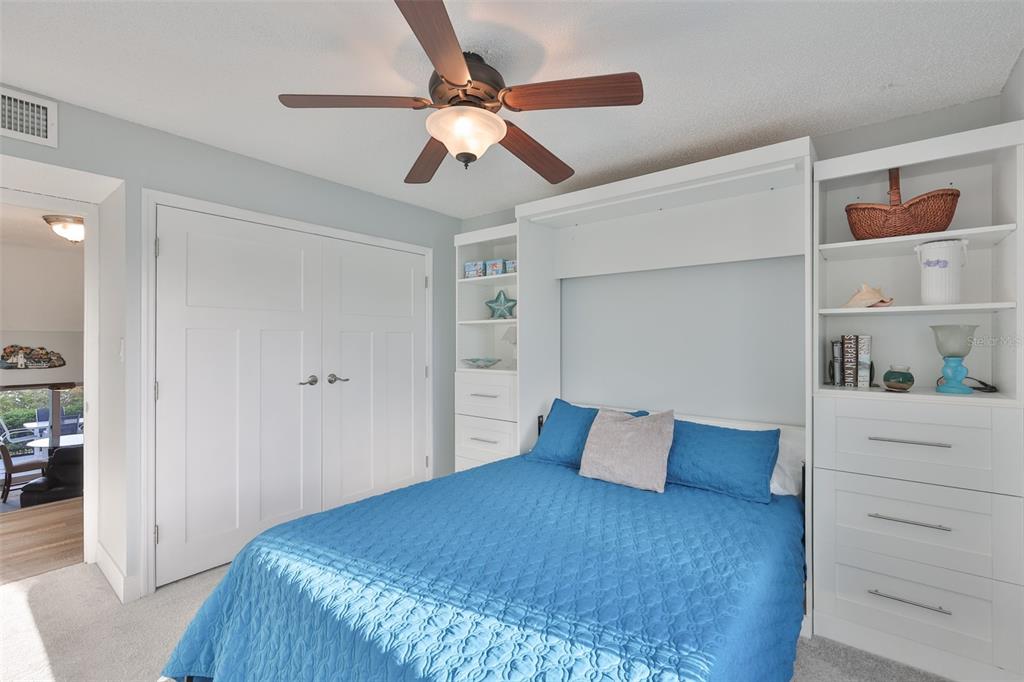 14800 Walsingham Road, Unit 1203 Largo, FL 33774 - Photo 22 of 68 a bedroom with a bed and a closet