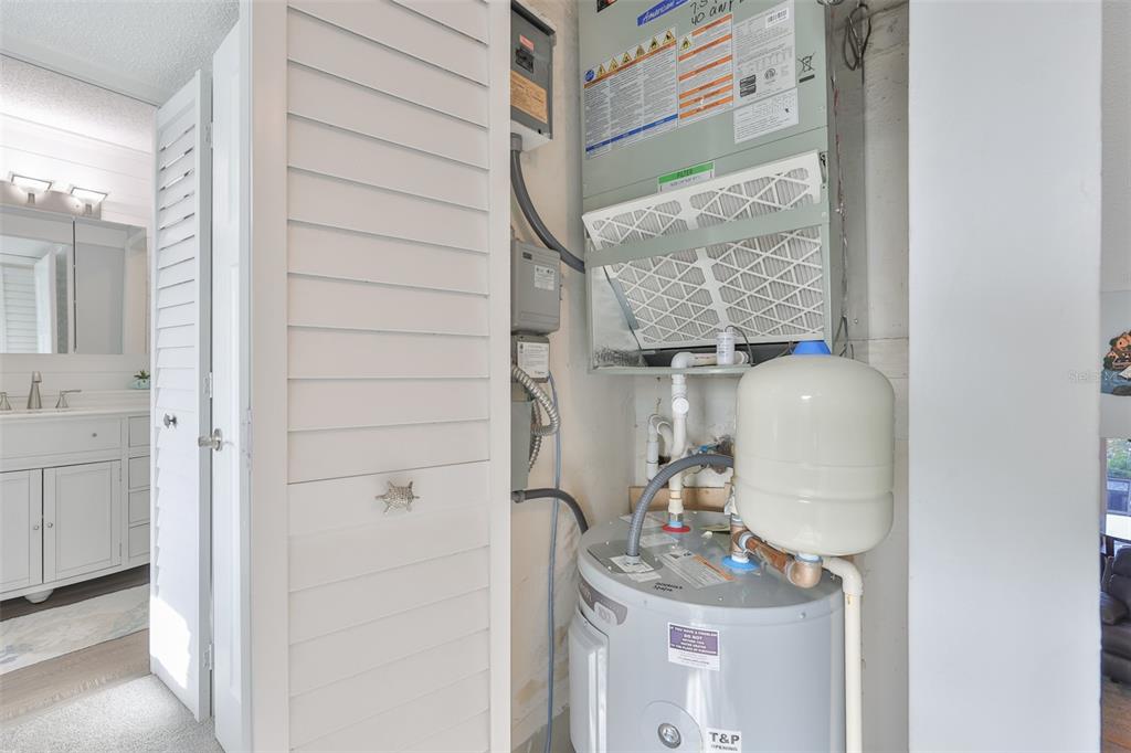 14800 Walsingham Road, Unit 1203 Largo, FL 33774 - Photo 29 of 68 a room with a sink and a mirror