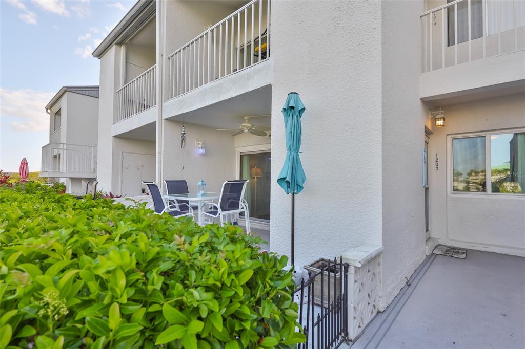 14800 Walsingham Road, Unit 1203 Largo, FL 33774 - Photo 33 of 68 a view of a house with backyard and sitting area