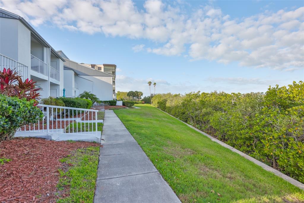 14800 Walsingham Road, Unit 1203 Largo, FL 33774 - Photo 35 of 68 a view of a garden with a pathway