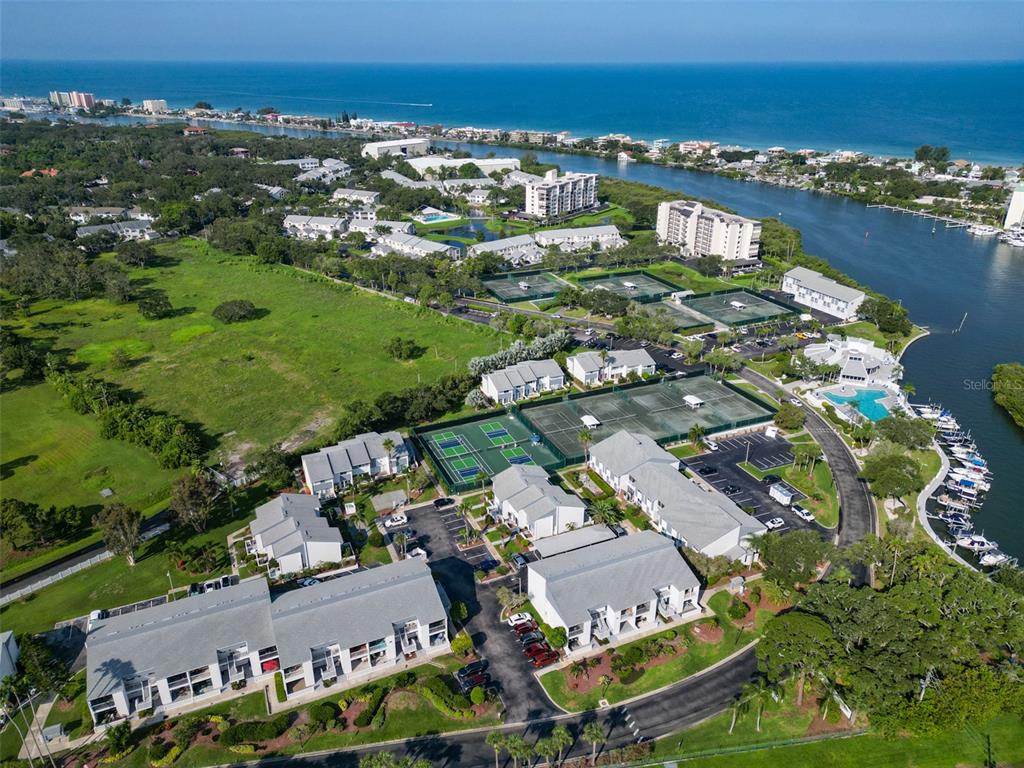 14800 Walsingham Road, Unit 1203 Largo, FL 33774 - Photo 48 of 68 an aerial view of a city with lots of residential buildings ocean and mountain view in back