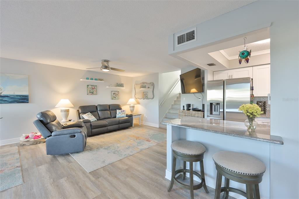 14800 Walsingham Road, Unit 1203 Largo, FL 33774 - Photo 5 of 68 a living room with furniture and a wooden floor