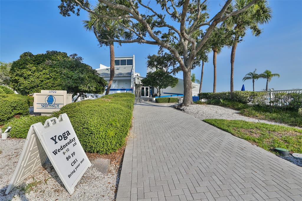 14800 Walsingham Road, Unit 1203 Largo, FL 33774 - Photo 51 of 68 a view of a street with potted plants and large trees