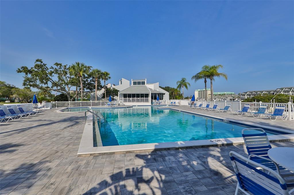 14800 Walsingham Road, Unit 1203 Largo, FL 33774 - Photo 57 of 68 a view of a swimming pool with a yard and seating area