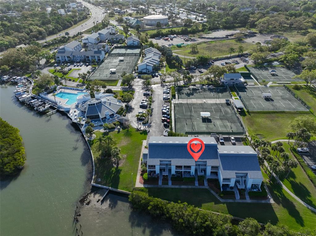 14800 Walsingham Road, Unit 1203 Largo, FL 33774 - Photo 67 of 68 an aerial view of residential houses with outdoor space and lake view