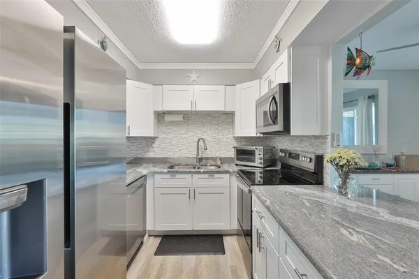 a kitchen with a sink stove and cabinets