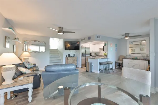 a living room with furniture and kitchen view