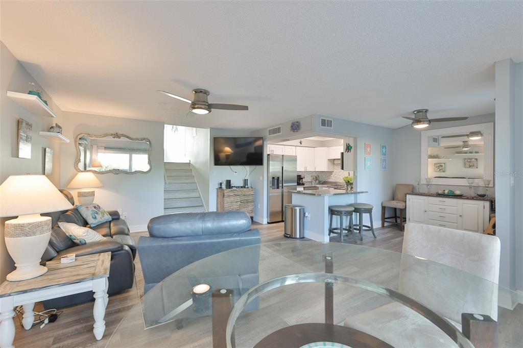 14800 Walsingham Road, Unit 1203 Largo, FL 33774 - Photo 8 of 68 a living room with furniture and kitchen view