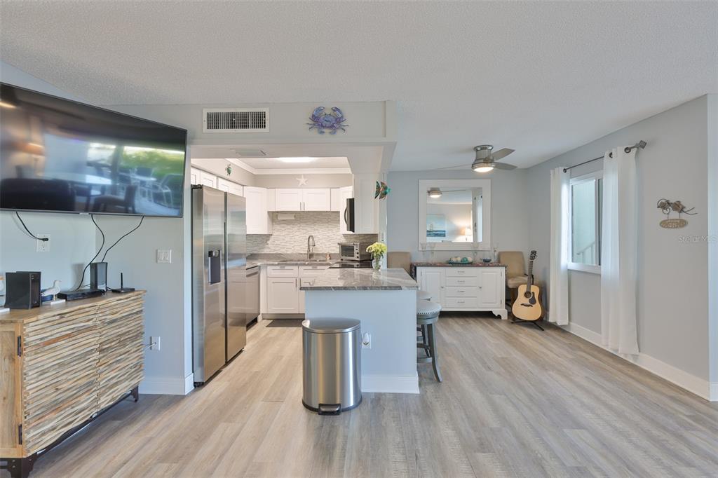 14800 Walsingham Road, Unit 1203 Largo, FL 33774 - Photo 9 of 68 a kitchen with a refrigerator and a sink