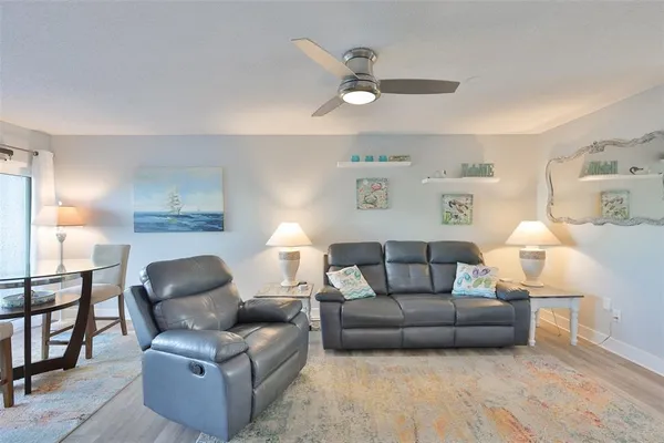 a living room with furniture and a wooden floor
