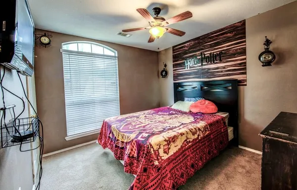 a bathroom with a sink a toilet a mirror and shower