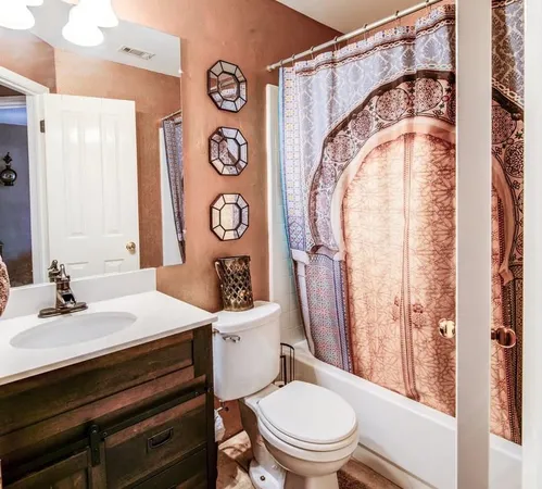 a bedroom with a bed dresser and a window