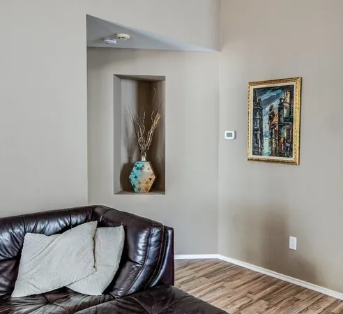 a spacious bedroom with a bed window and a chandelier