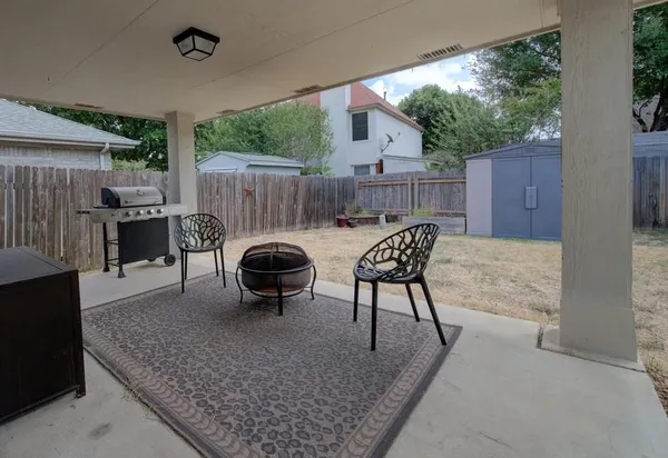 a view of a house with backyard and sitting area