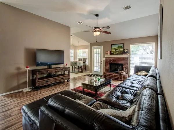 a living room with furniture a flat screen tv and a fireplace
