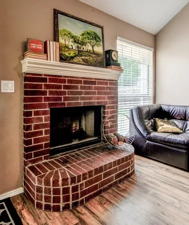 a living room with furniture a rug and a fireplace