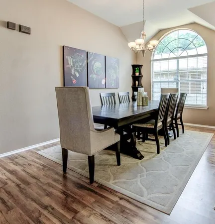 a view of a dining room with furniture wooden floor and chandelier
