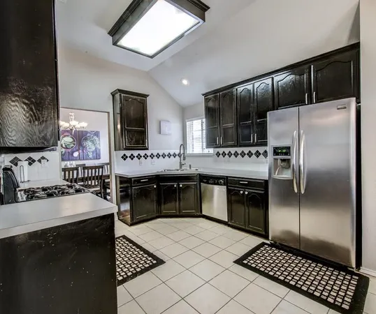 a kitchen with a refrigerator sink and stove