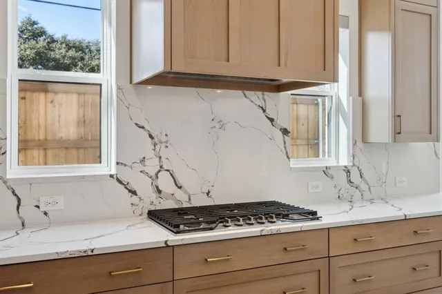 a kitchen with granite countertop a sink and a window