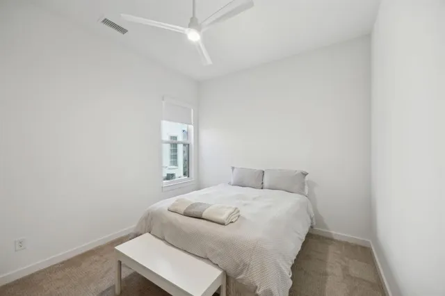 a bedroom with a bed and a chair