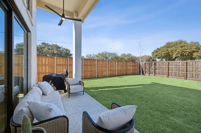 a view of a patio with couches chairs and a yard