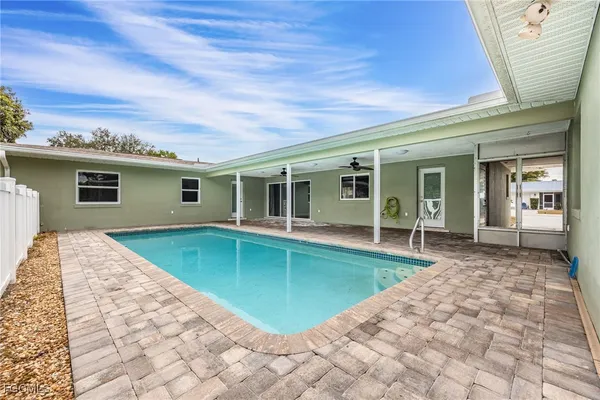 a view of a house with a backyard