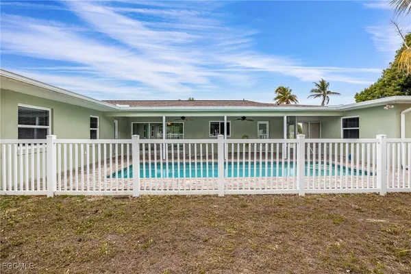 a swimming pool with yard in front of it