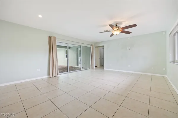 a view of an empty room with a chandelier