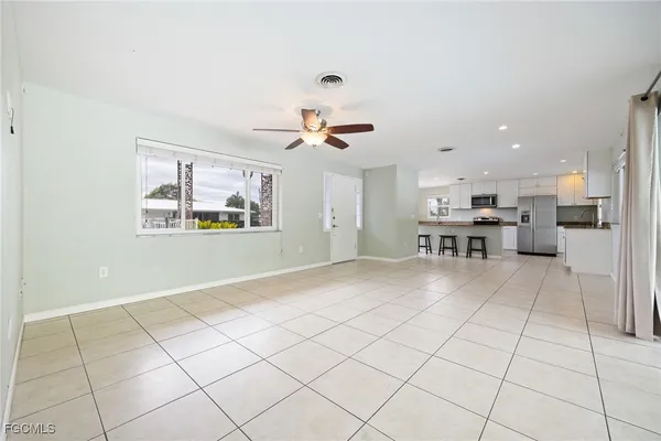 a kitchen with granite countertop a refrigerator and a stove top oven