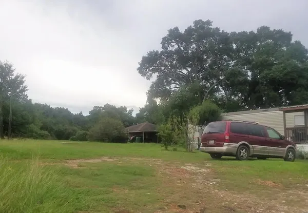 a view of a yard with car parked