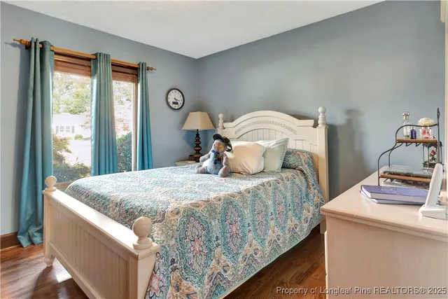 a bedroom with bed and window