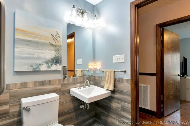 a bathroom with a toilet a sink and a mirror