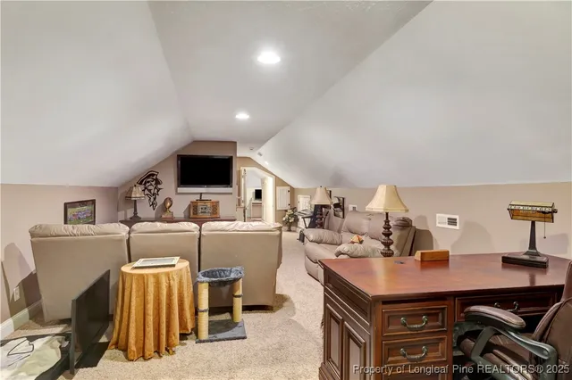 a living room with furniture and flat screen tv