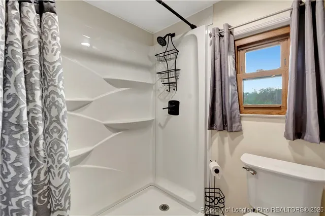 a bathroom with a shower and a toilet