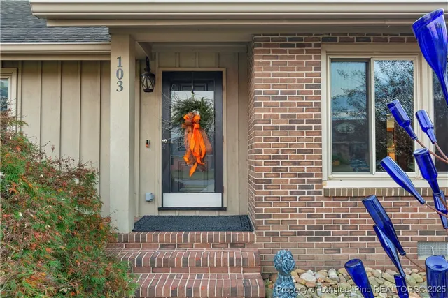 a view of front door and potted plants