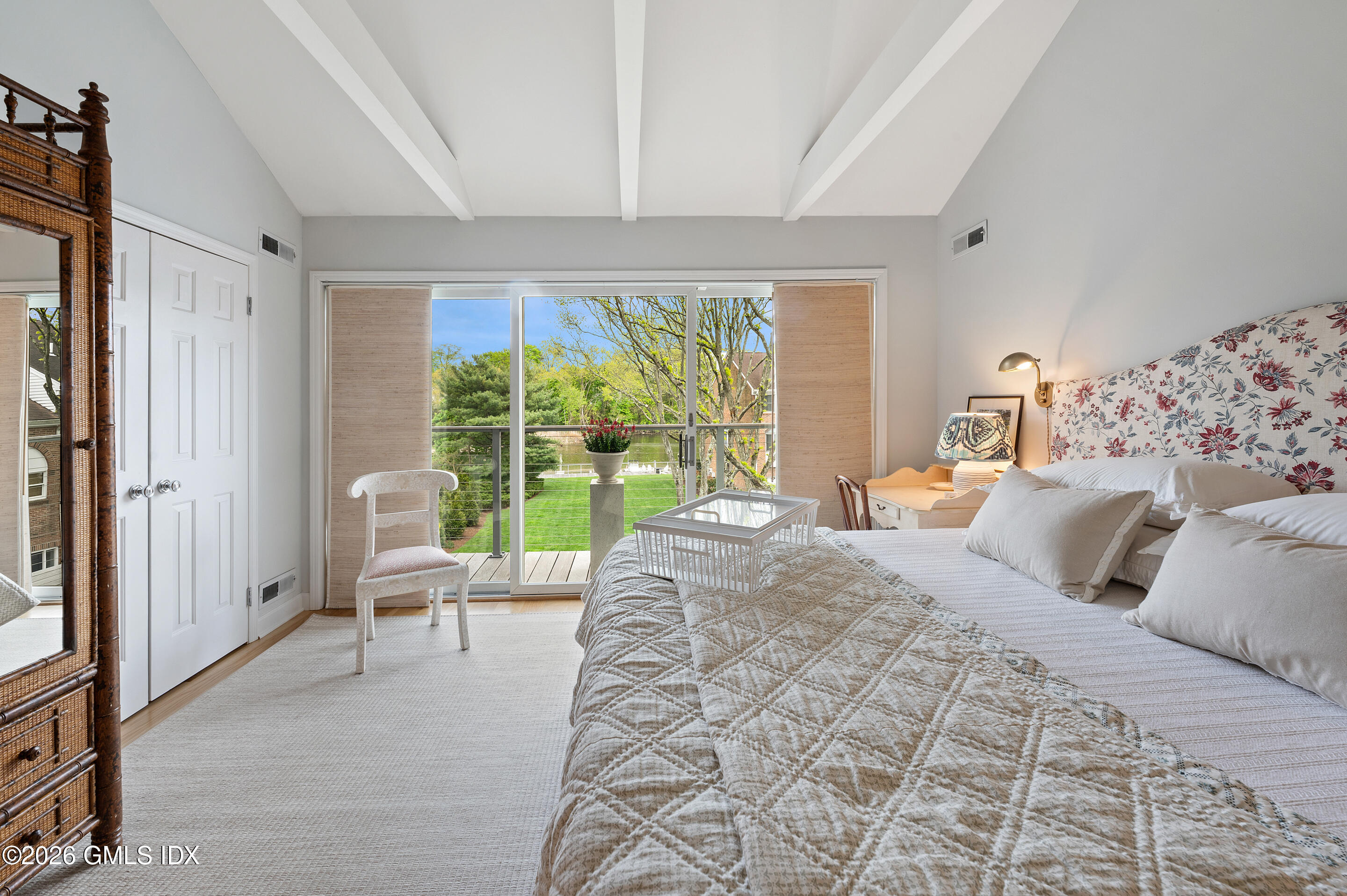 115 River Road, Unit 3 Cos Cob, CT 06807 - Photo 28 of 40 a bedroom with a bed and large windows