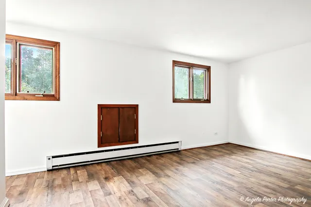a view of an empty room with closet and a window